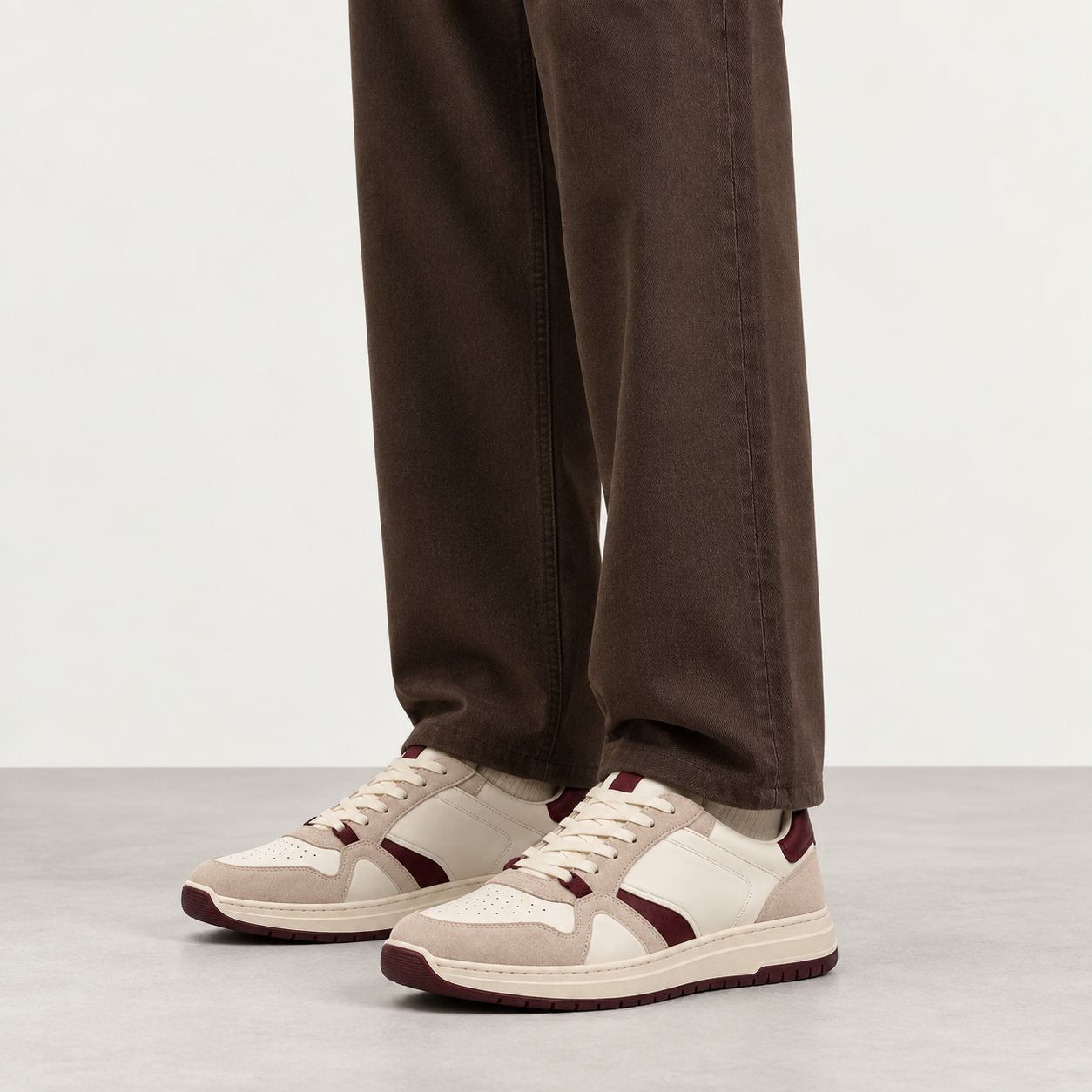 Ivory Burgundy Court Sneaker worn with trousers