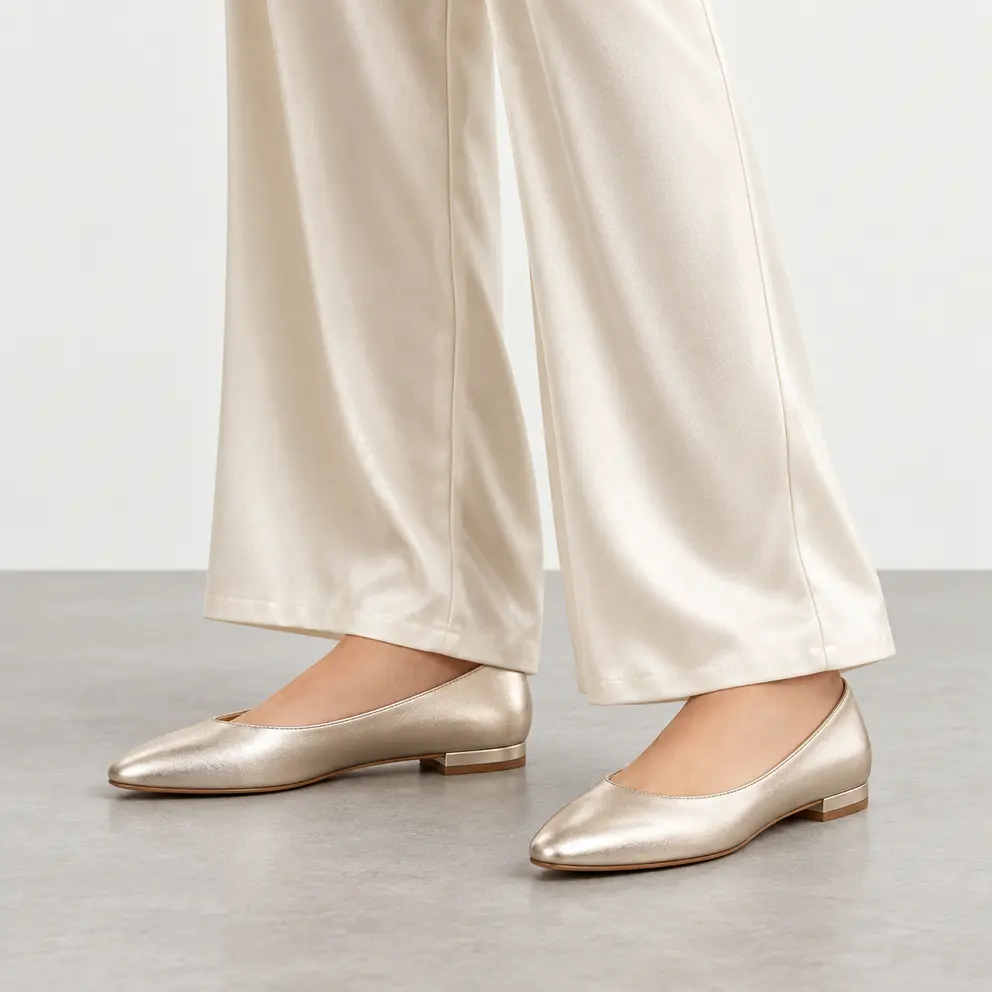Champagne Metallic Pointed Flat worn on foot